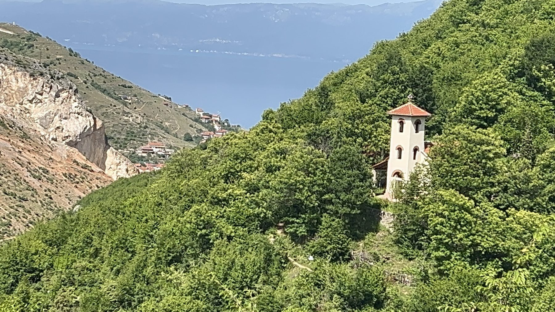 A view of Kisha Shën e Diela church as the Kabash Trail starts to descend from the U